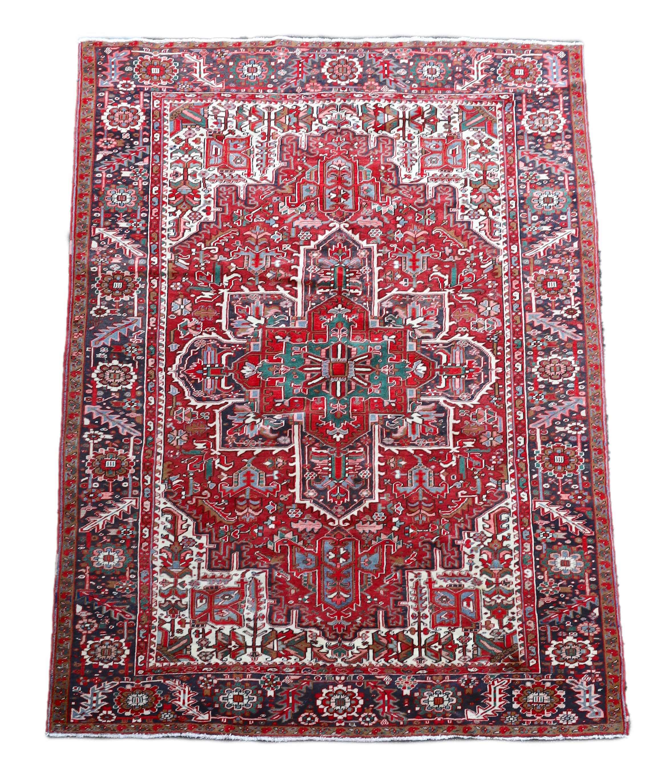 A Heriz red ground carpet, 324 x 243cm.